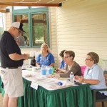 Fred at the registration desk s[peaking with Cheryl Smalley and Pat Haynes